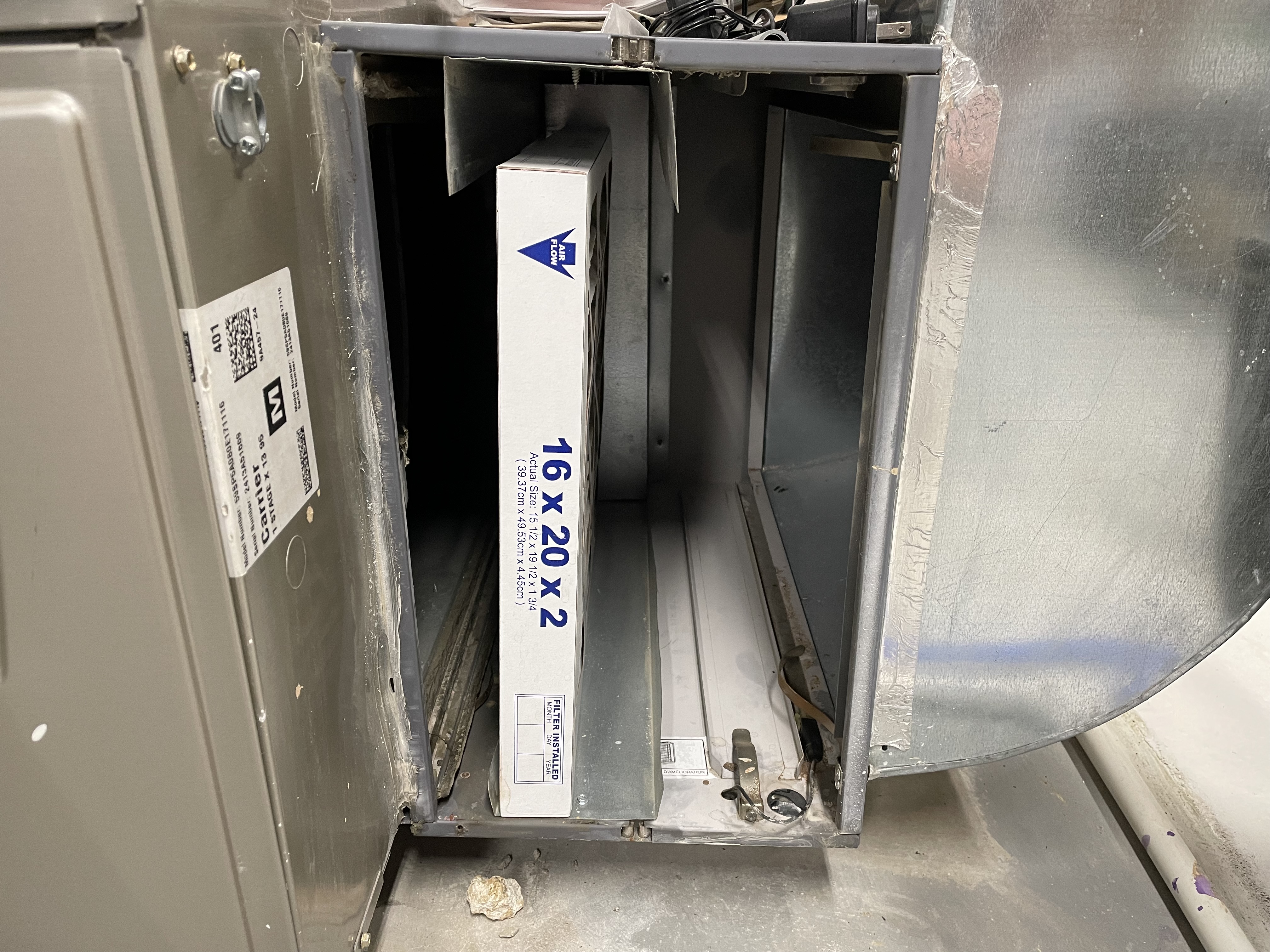 Air filter in an HVAC shown installed with a two inch gap around it, showing it's not the right size.